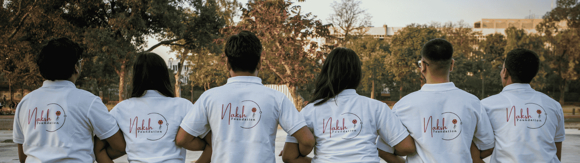 This photo shows a group of Naksh Foundation volunteers wearing official T-shirts, displaying the organization’s logo.